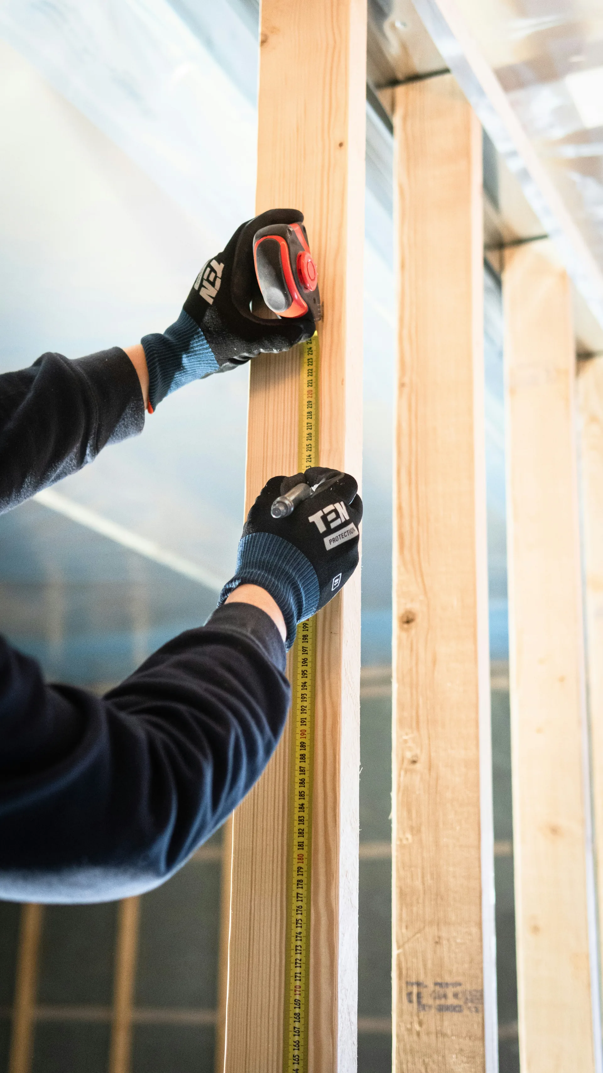 Close-up of wall framing and insulation during residential construction, showing the building envelope before air sealing